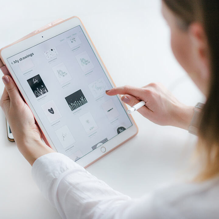 Woman using a tablet to view drawings.