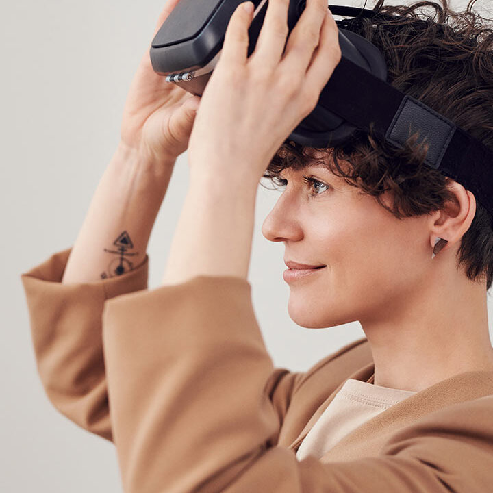 Woman putting on VR headset.