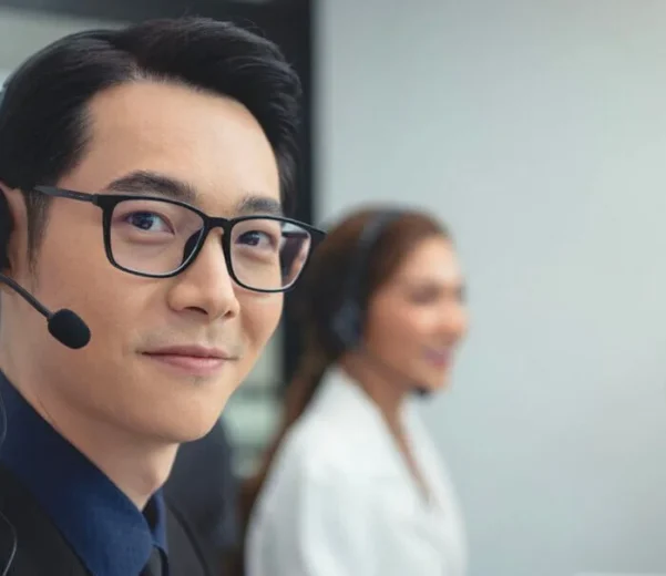 Man wearing glasses and headset in office.