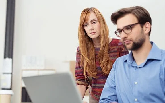 Woman and man looking at laptop.