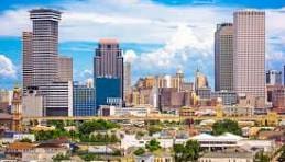 New Orleans skyline with skyscrapers and blue sky.