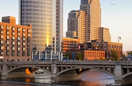 Downtown Detroit skyline with bridge and river.