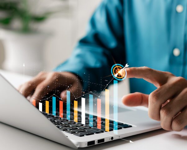 Person analyzing digital graph on laptop screen.