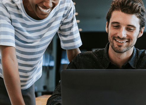 colleagues-discussing-their-work-laptop 1